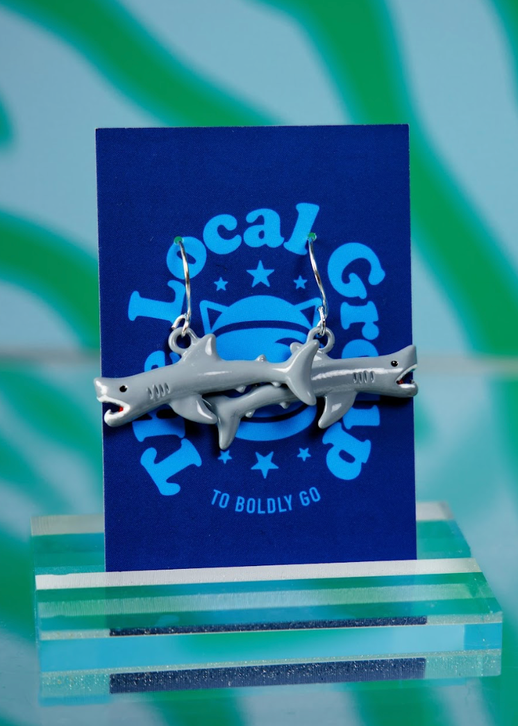 Shark earrings on a blue card with 'Local Grub' branding against a green and white striped background