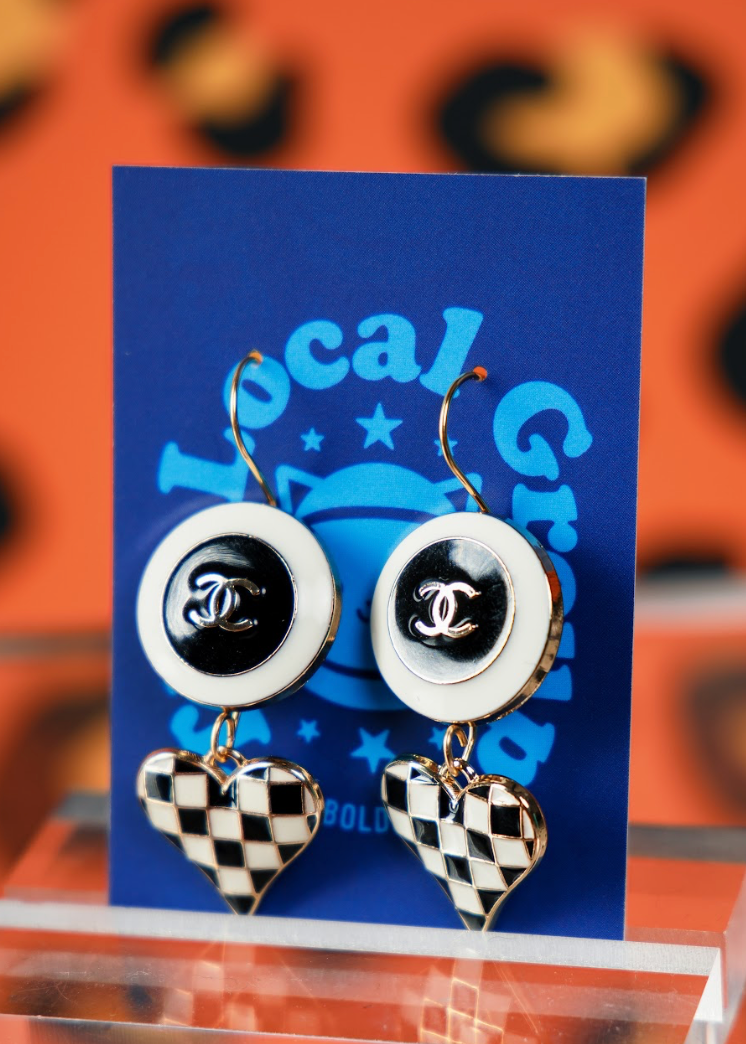 Pair of earrings with black and white design on a blue card with 'Local Grocer' branding.