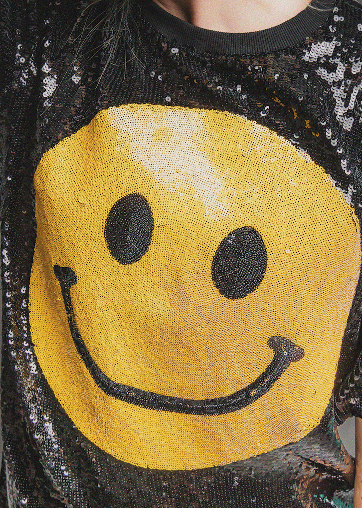 Black sequin dress with a yellow smiley face design